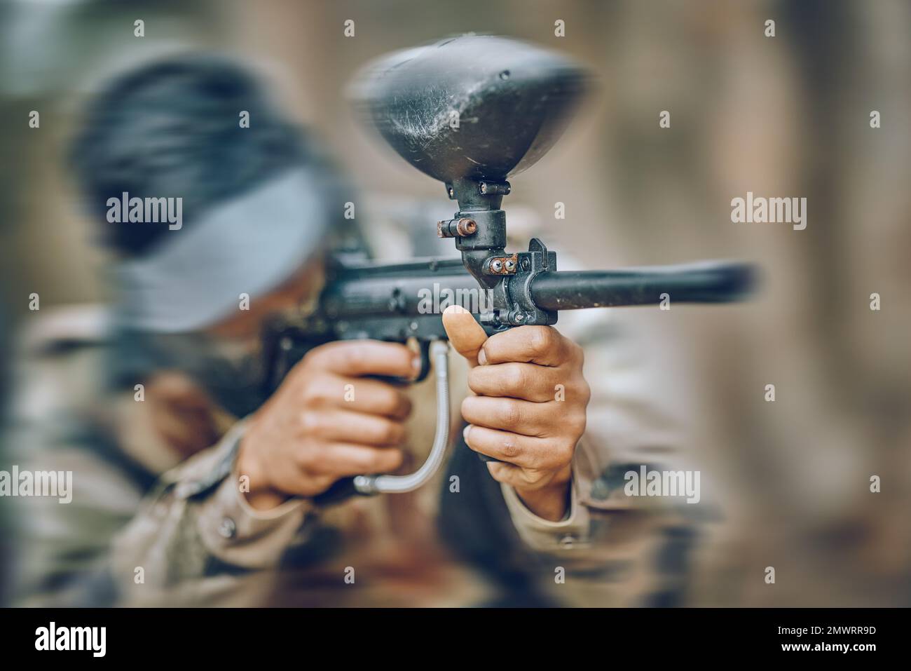 Paintball, gun and target with man, action and sports outdoor