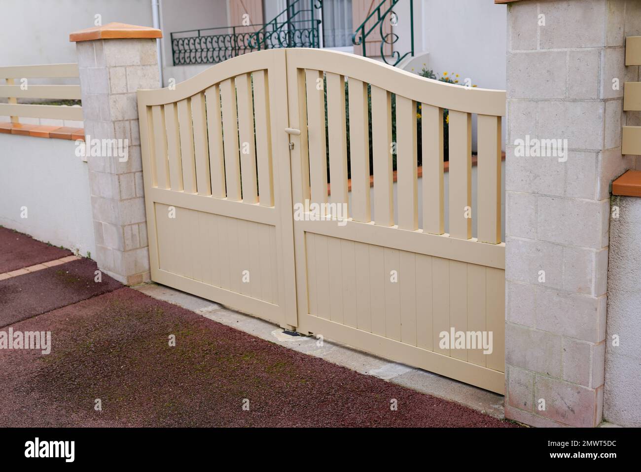 steel classic beige sand metal gate fence of house street view Stock Photo
