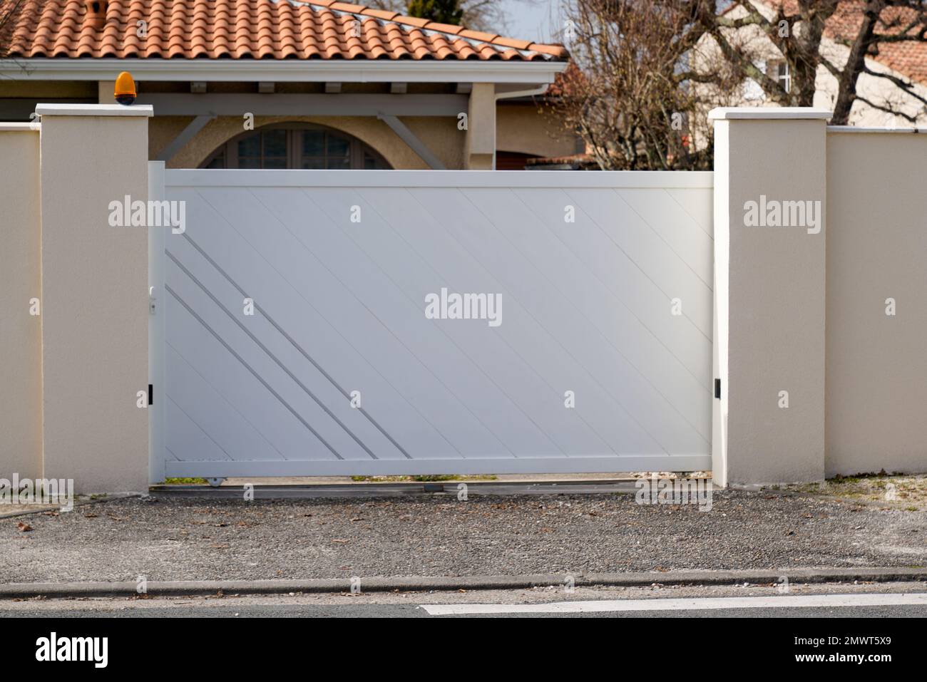 steel modern white gate aluminum portal with blades design of suburban house Stock Photo