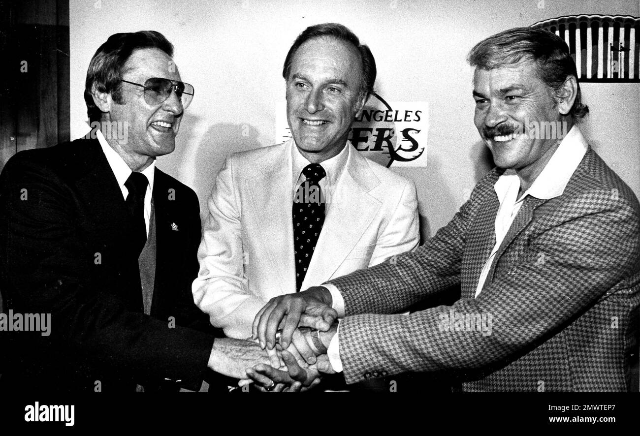 Los Angeles Lakers general manager Bill Sharman, left, and owner Jerry  Buss, right, congratulate Jack McKinney, center, upon announcing that  McKinney is the new head coach of the Lakers in Inglewood, Calif.,