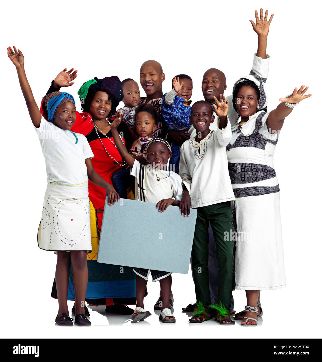 Mexican wave More like African wave. Studio shot of a large african family holding a blank board, isolated on white. Stock Photo