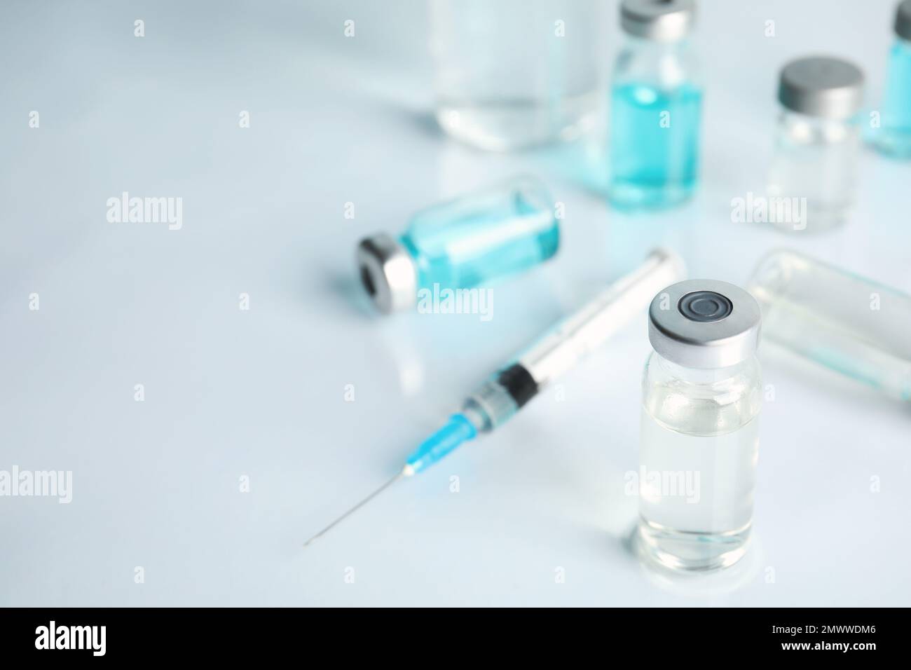 Vials and syringe on light table. Vaccination and immunization Stock ...