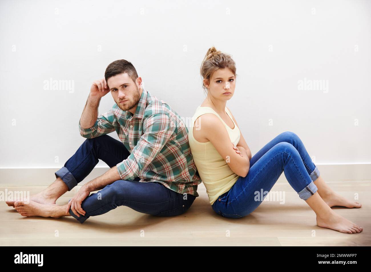 No compromise. a young couple having relationship difficulties sitting back to back. Stock Photo