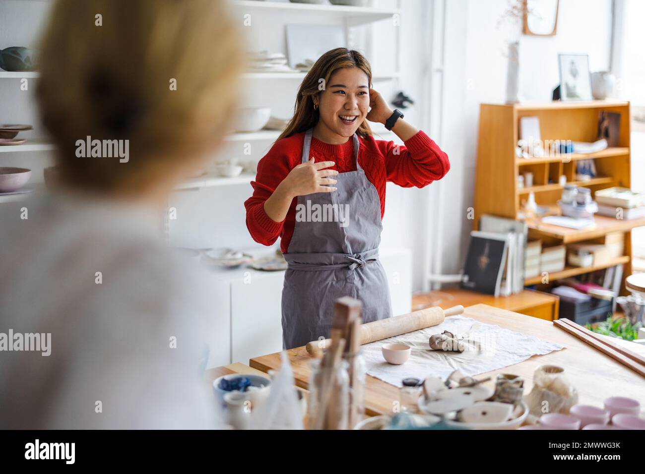 Young woman working in a pottery studio Stock Photo