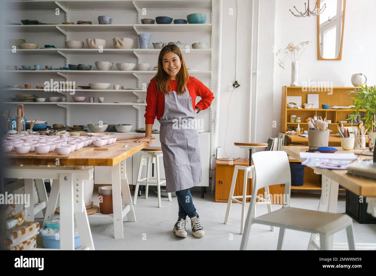 Young woman working in a pottery studio Stock Photo