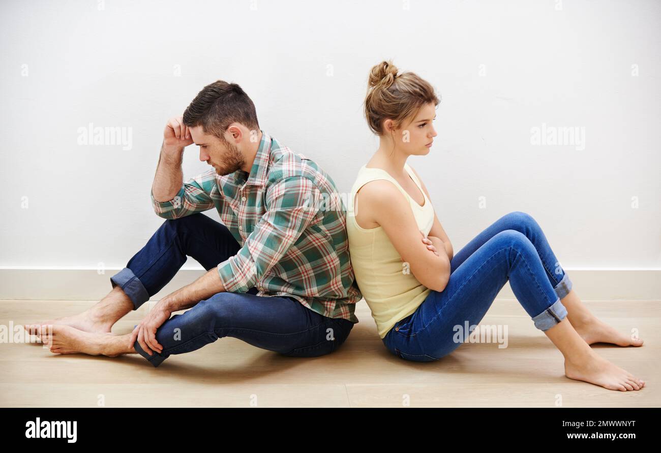 Every marriage has its bad days. a young couple having relationship difficulties sitting back to back. Stock Photo