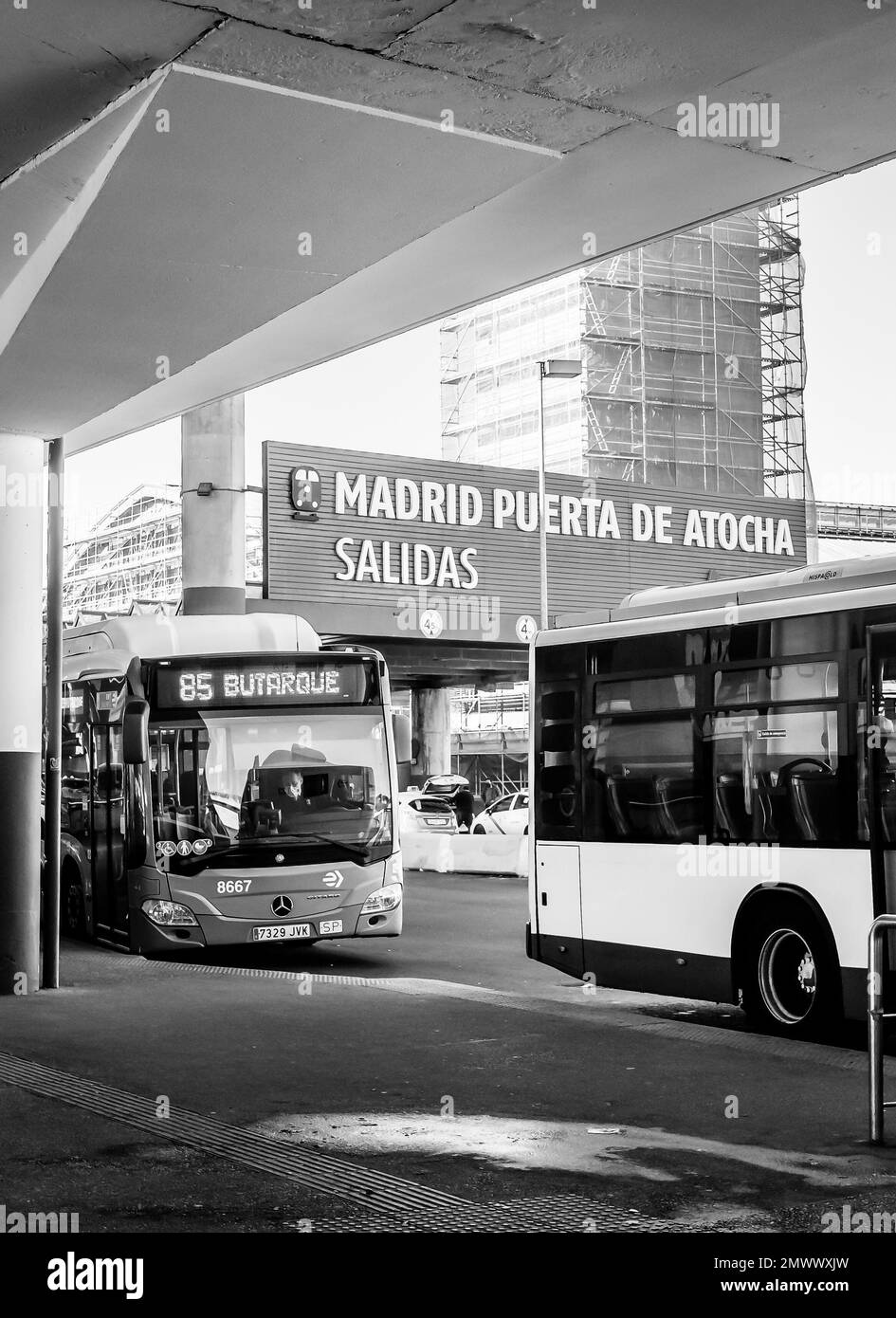 An EMT blue bus and airport bus outside Atocha railway station that has just arrived at the end of the journey from the airport. Stock Photo