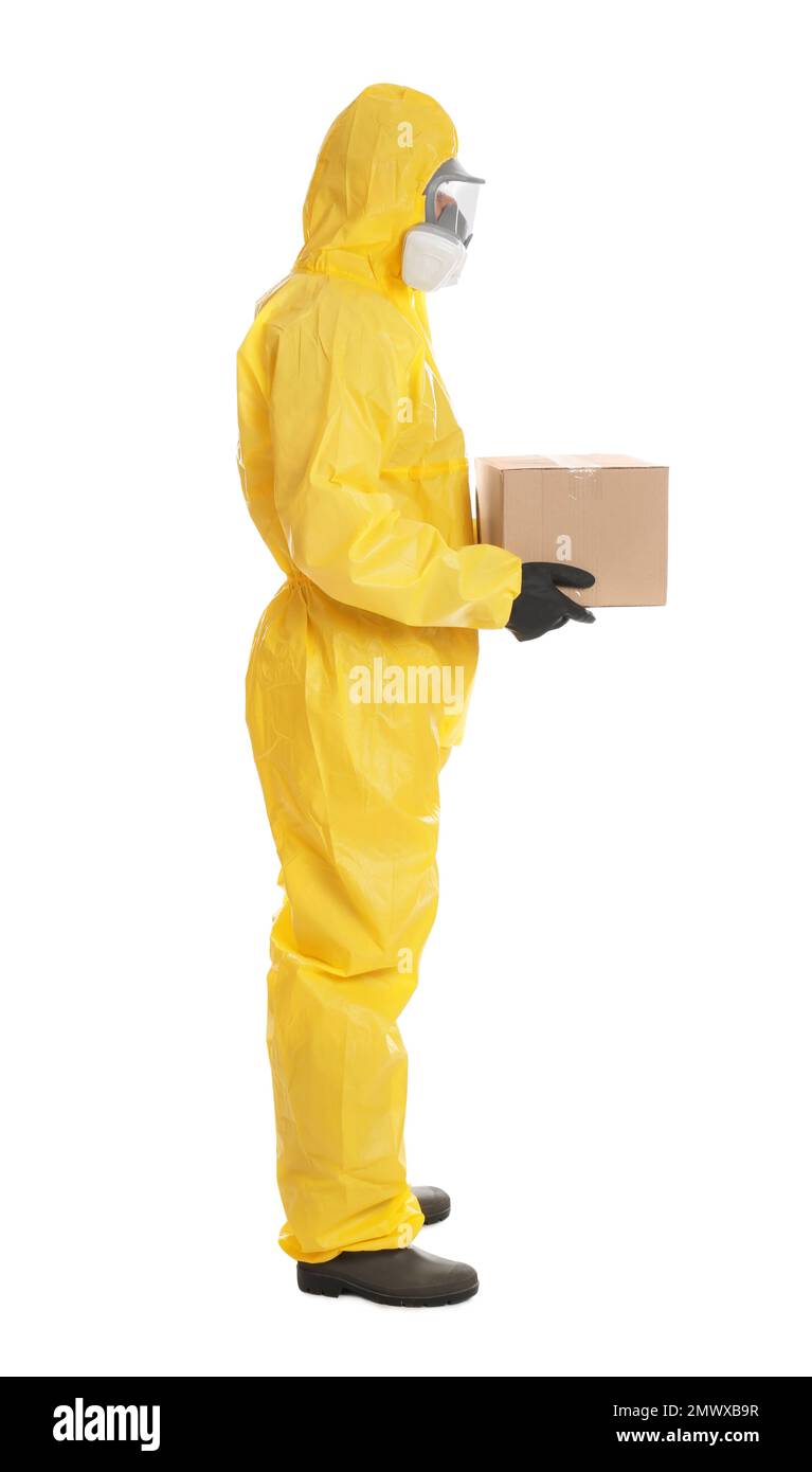 Man wearing chemical protective suit with cardboard box on white background. Prevention of virus spread Stock Photo