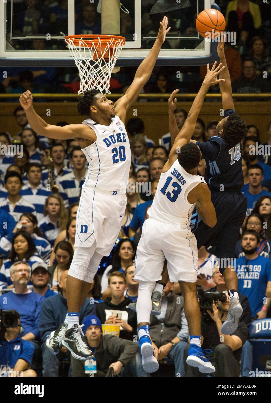 Maine's Wes Myers (10) Attempts A Shot As Duke's Marques Bolden (20 