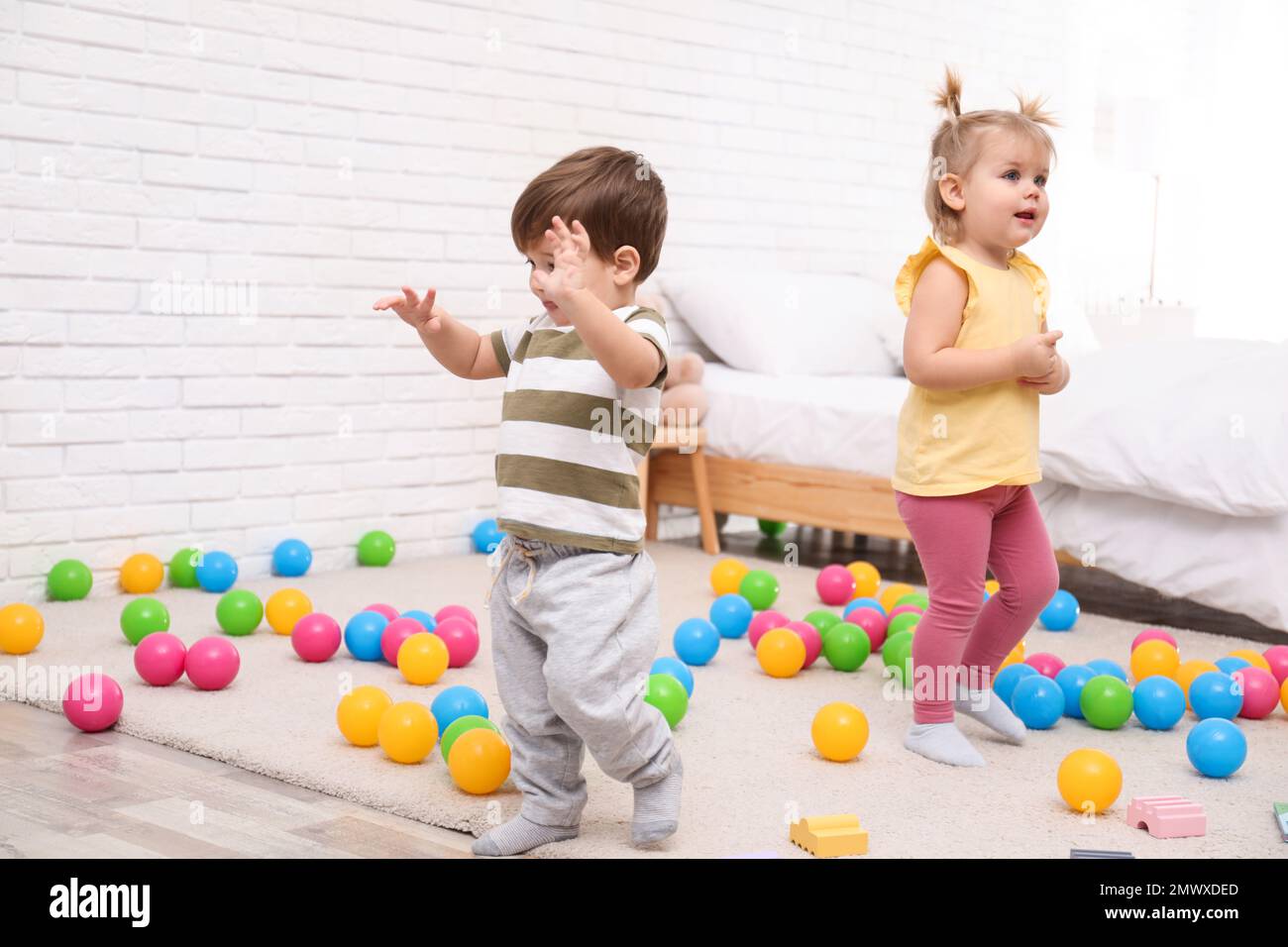 Cute little children playing together at home Stock Photo - Alamy