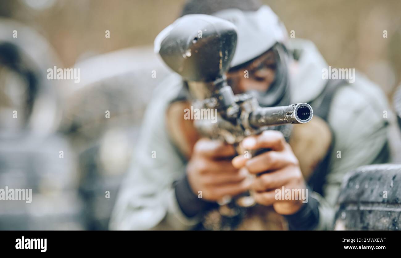 Paintball gun zoom, target and sports outdoor with black man and fitness, battlefield challenge