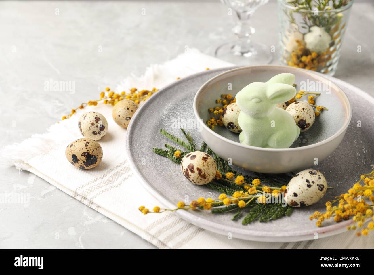 Festive Easter table setting with beautiful mimosa flowers Stock Photo