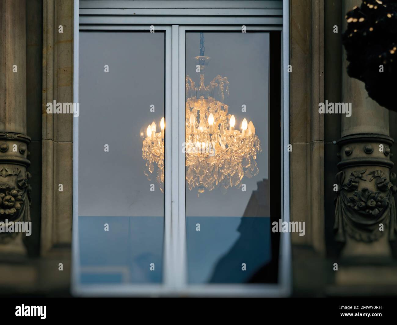 View of Luxury crystal chandelier lit on the ceiling of a luxury real estate ...