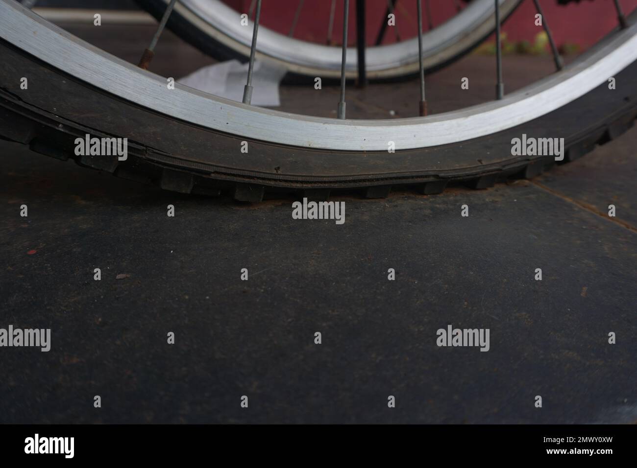 flat bicycle tire in front of the house in the morning Stock Photo Alamy