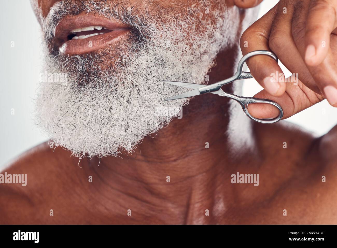 Trimming, beard and face of a man with a scissors isolated on a white