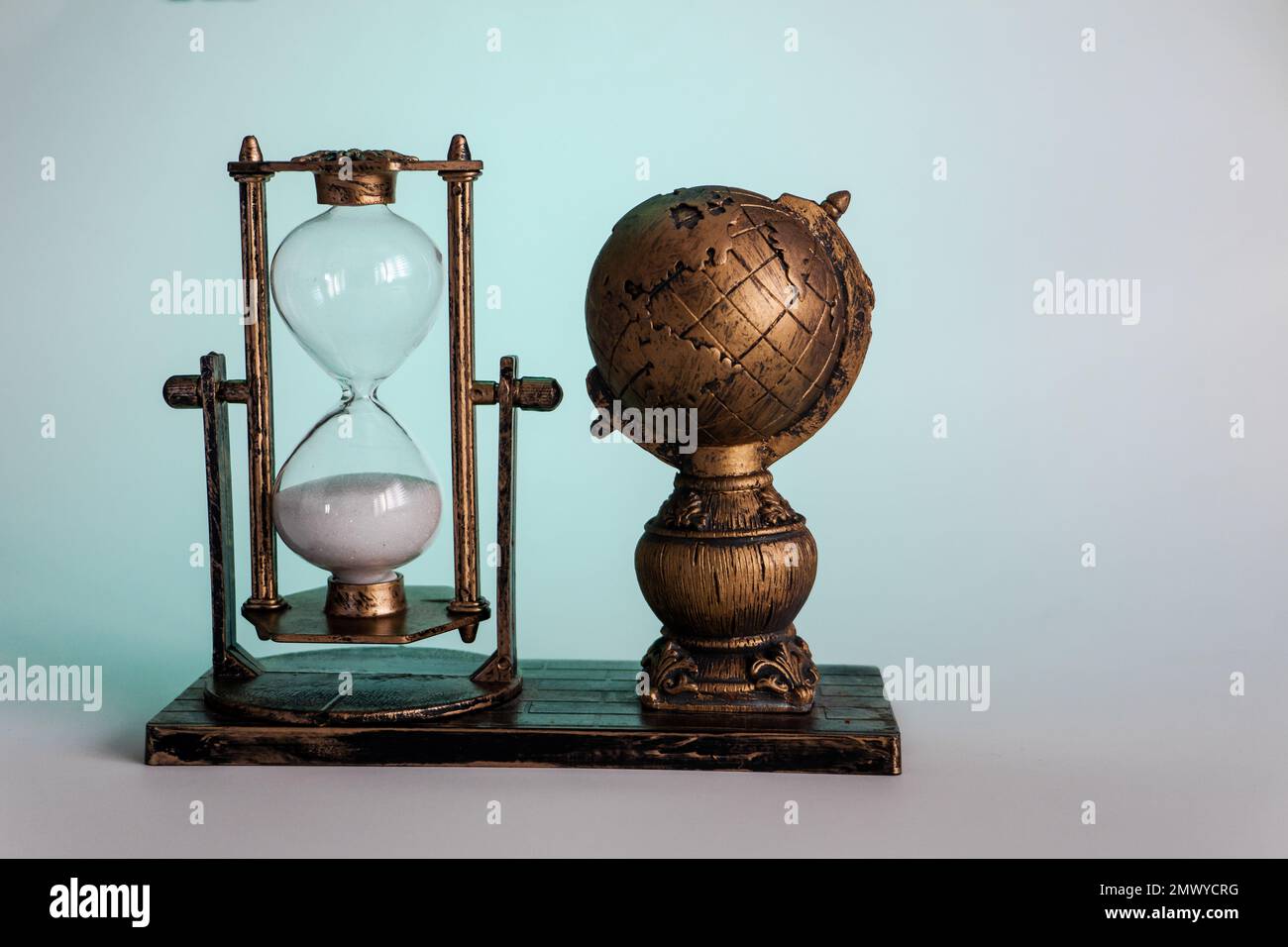 Earth and Hourglass. The symbolism of hourglasses Stock Photo