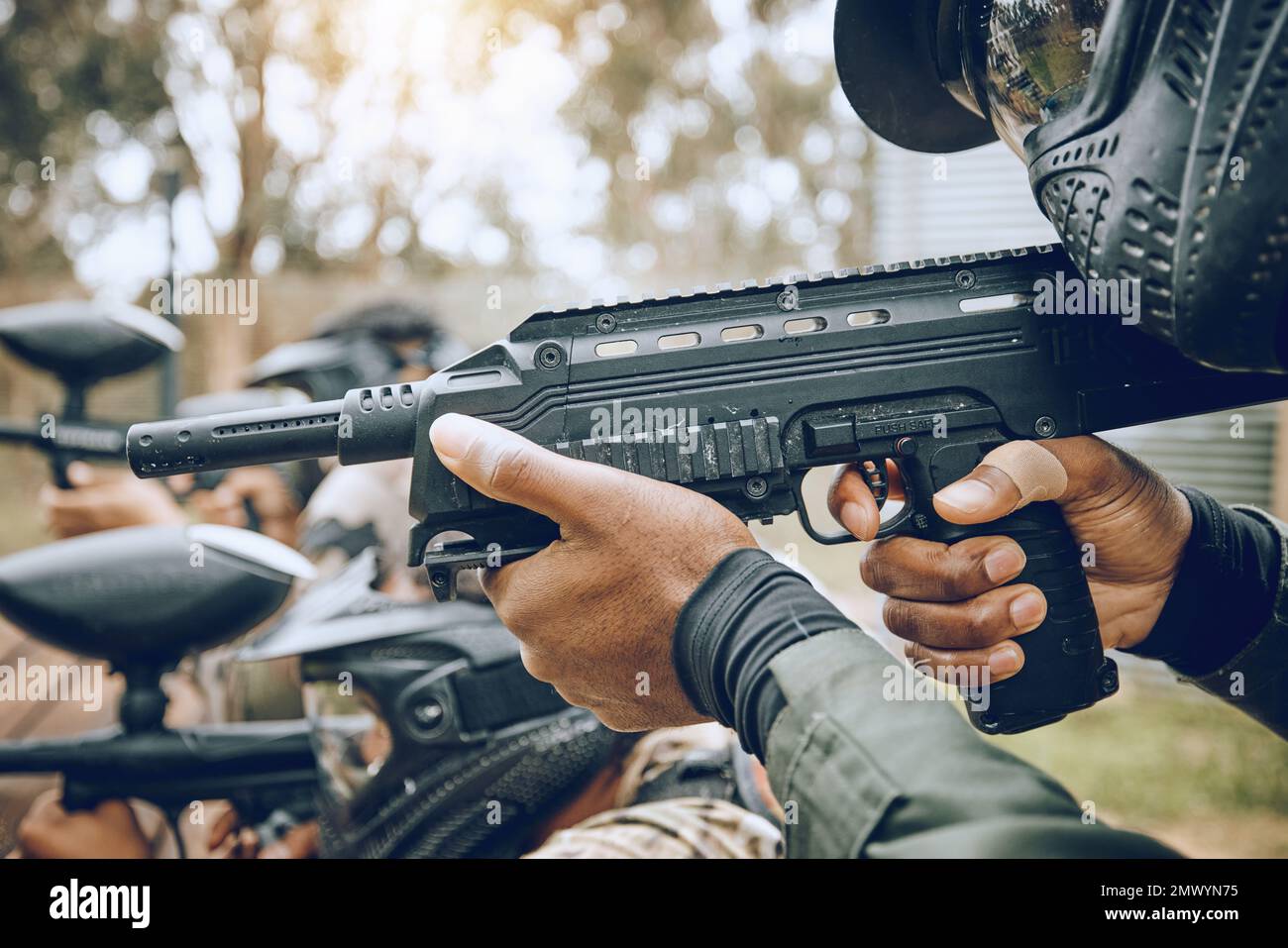 Paintball, gun and target with team, action and sports outdoor, people