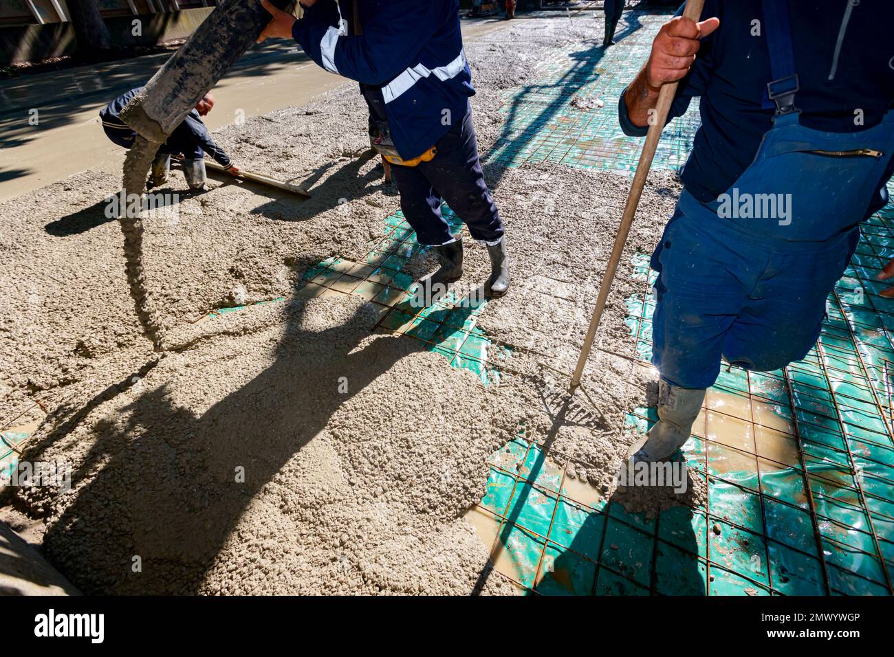 Construction worker is directing the pump tube on right direction