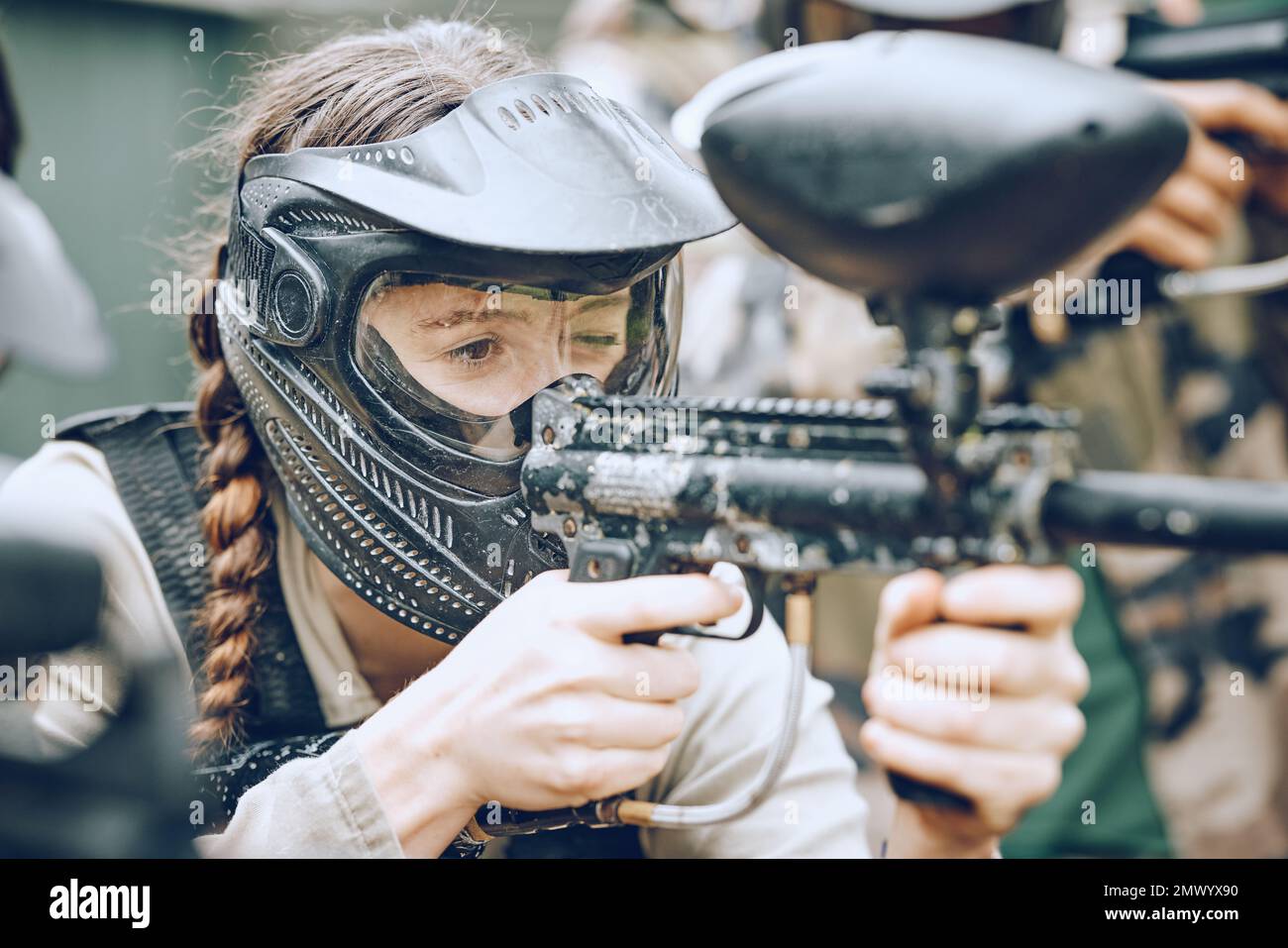 Paintball, gun and woman with helmet aim for shooting ready for game