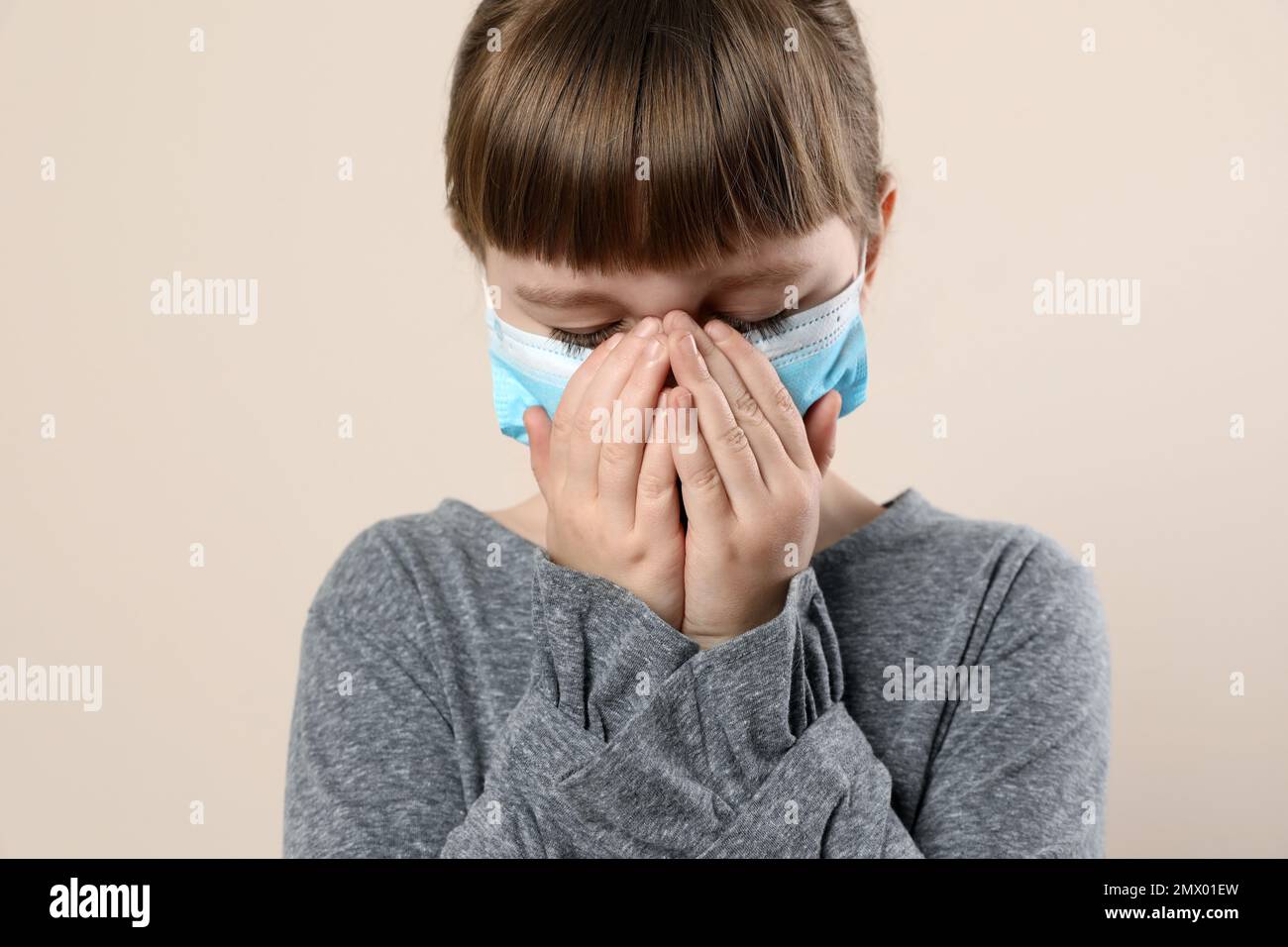 Little girl in medical mask on beige background. Virus protection Stock ...