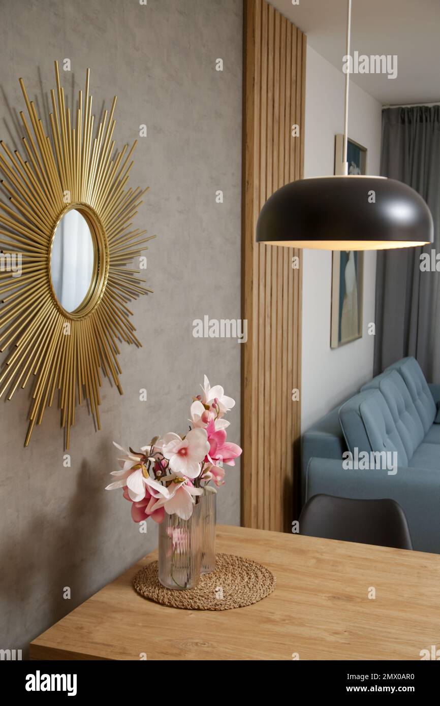 Interior design details, flower arrangements on the wooden table, lamp ...