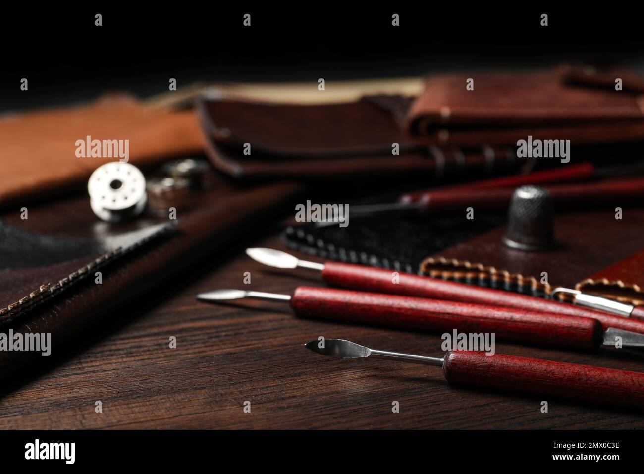 Leather samples and tools on wooden table Stock Photo