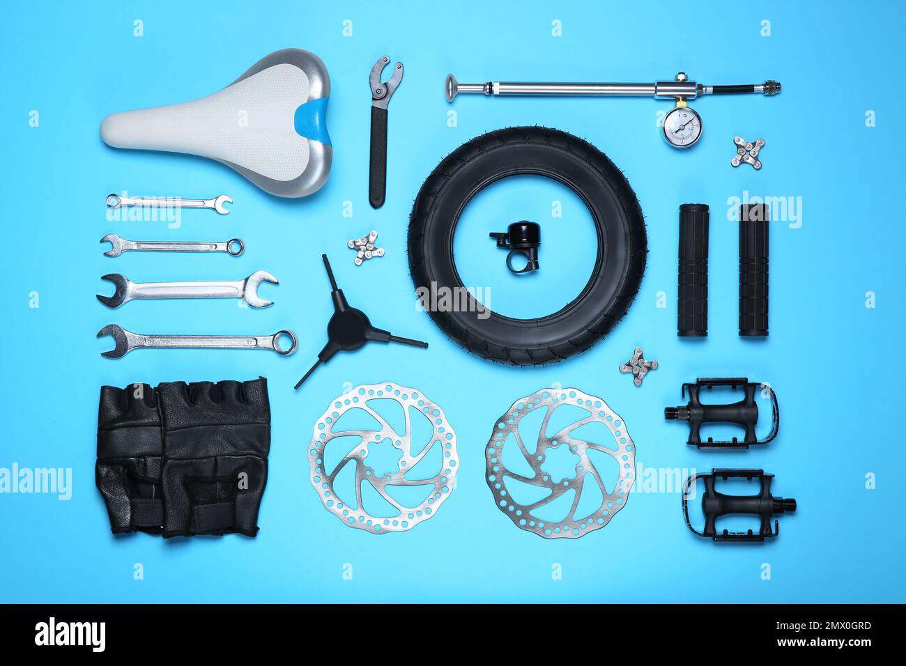 Set of different bicycle tools and parts on light blue background, flat