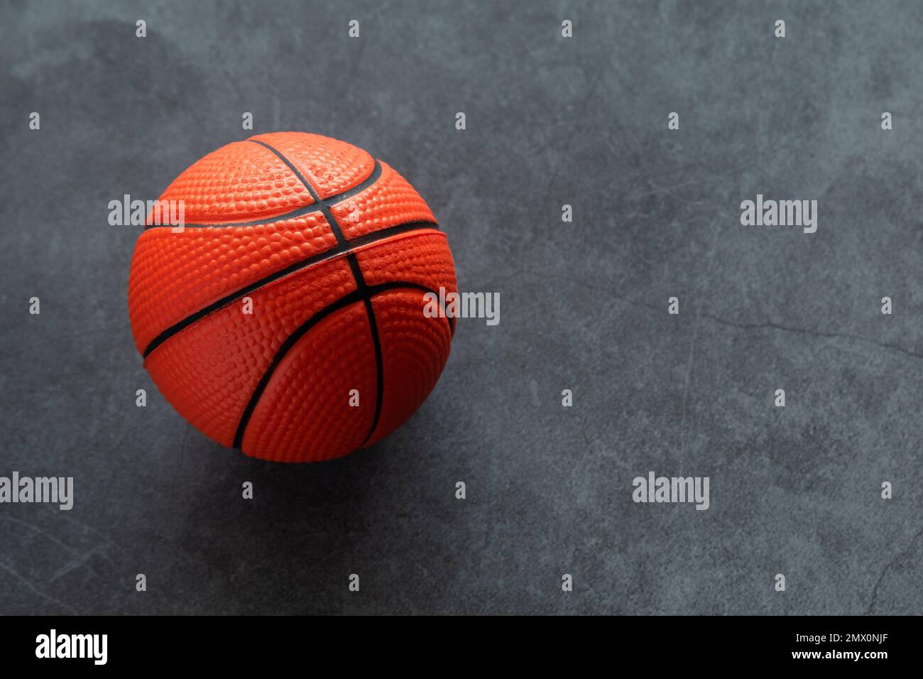Small soft foam basketball on dark background Stock Photo