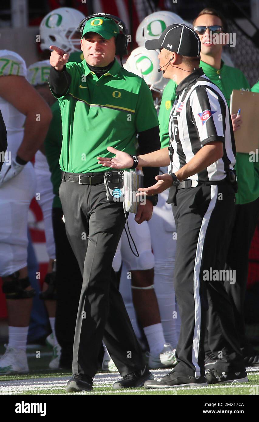 Oregon head coach Mark Helfrich, talks to an official in the second half during an NCAA college