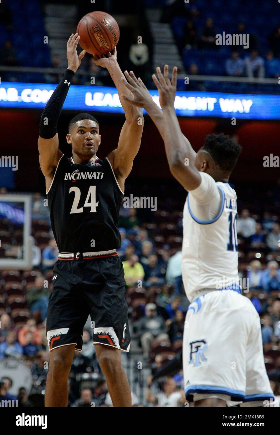 Cincinnati's Kyle Washington shoots over Rhode Island's Cyril Langevine