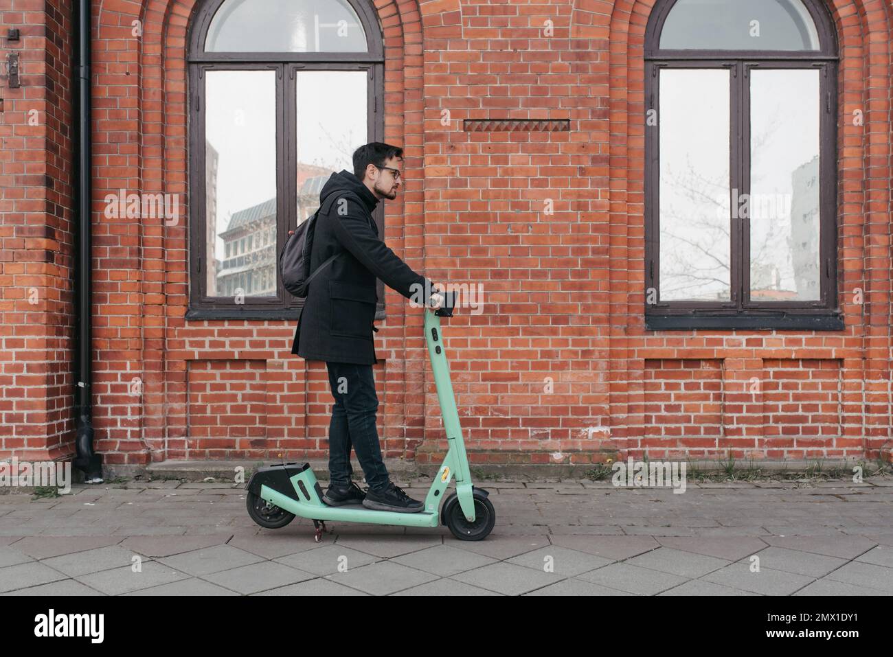 Man using electric push scooter hi-res stock photography and images - Alamy