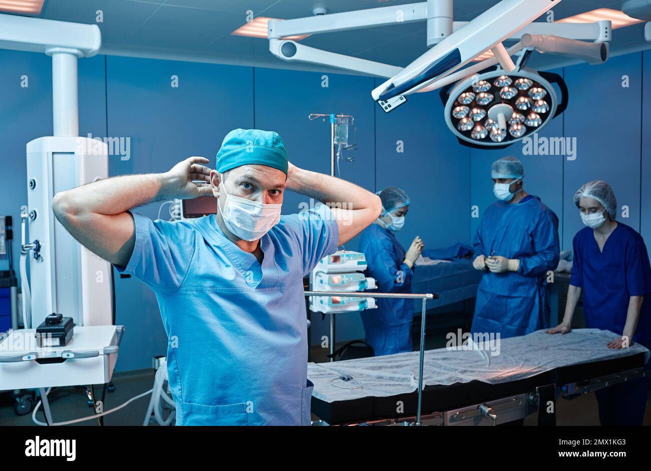 Surgical team getting ready for beginning of surgical operation in operating room Stock Photo