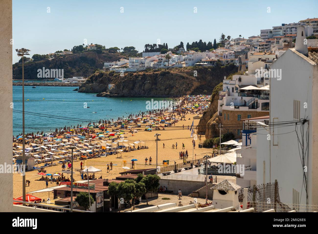 View of a crowded beach in the hot summer in the city of Albufeira