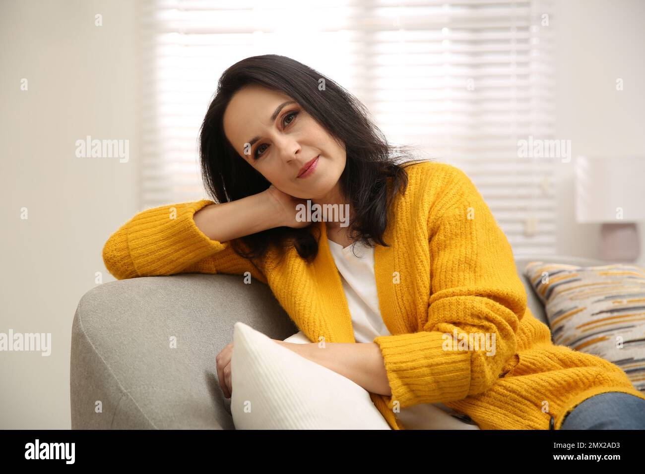 Mature woman on sofa hi-res stock photography and images - Alamy