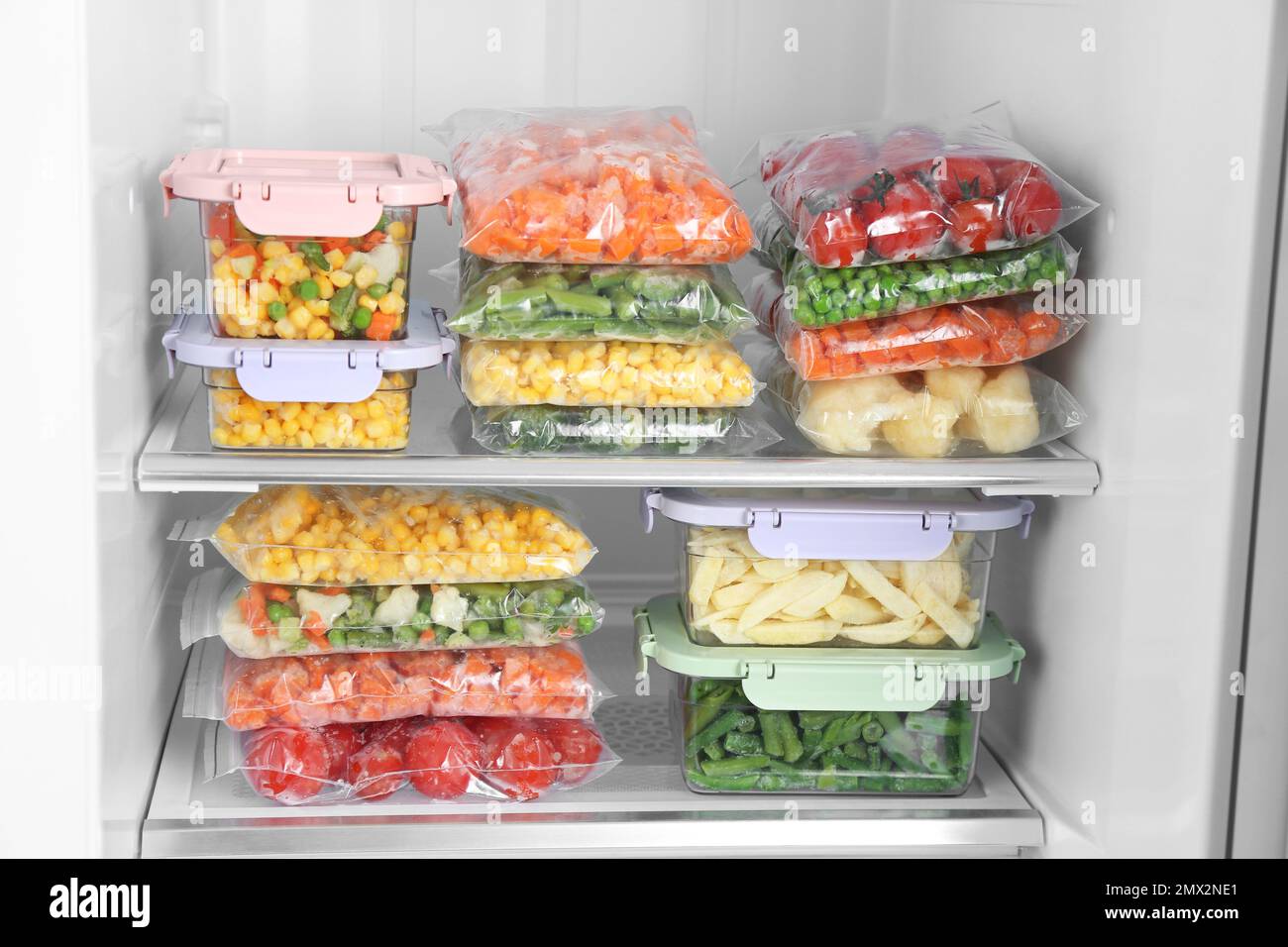 Containers and plastic bags with frozen vegetables in refrigerator Stock  Photo - Alamy