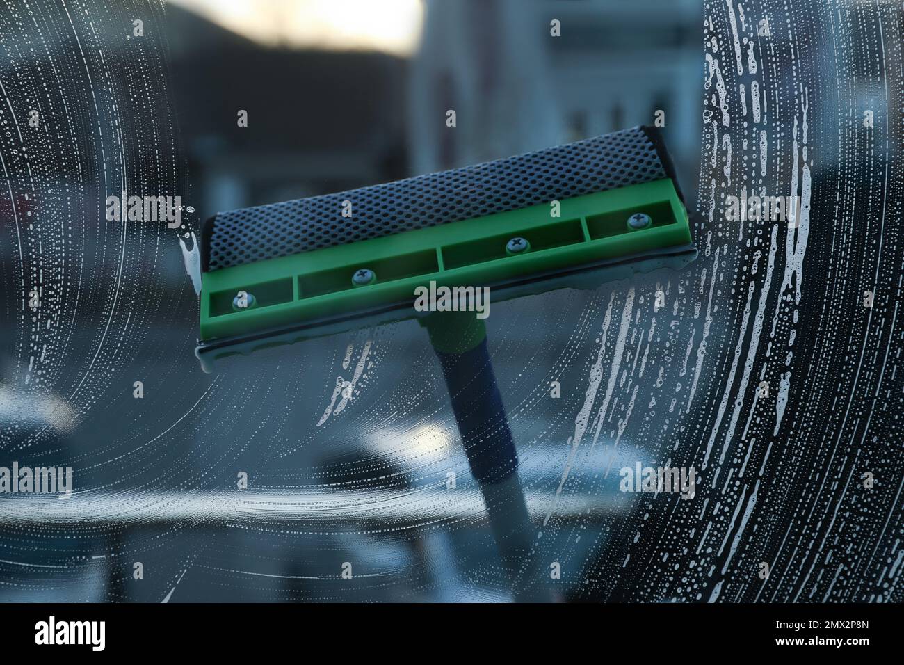 Cleaning window with squeegee indoors. Household chores Stock Photo Alamy