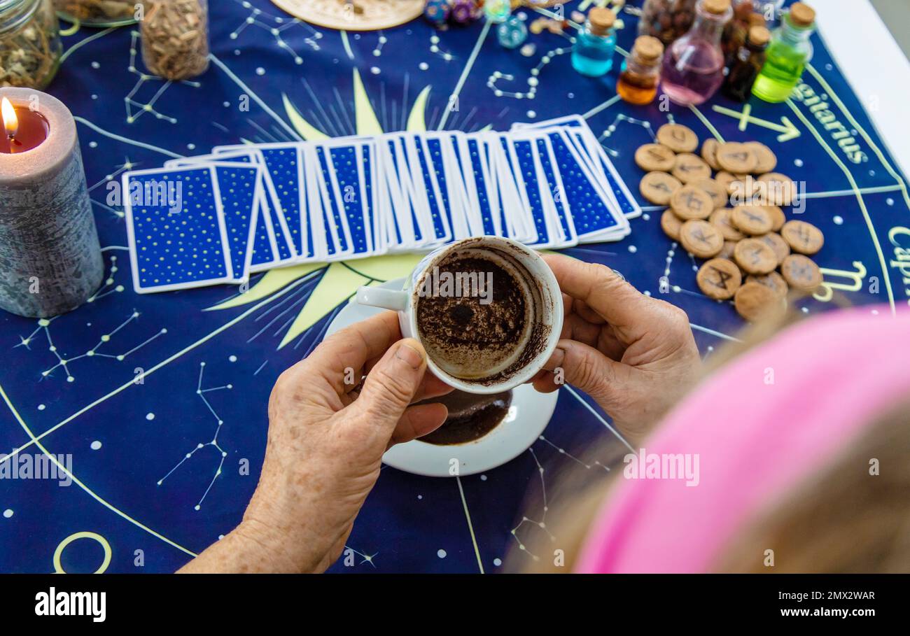A fortune teller reads fortunes on coffee grounds. Selective focus. Woman Stock Photo Alamy
