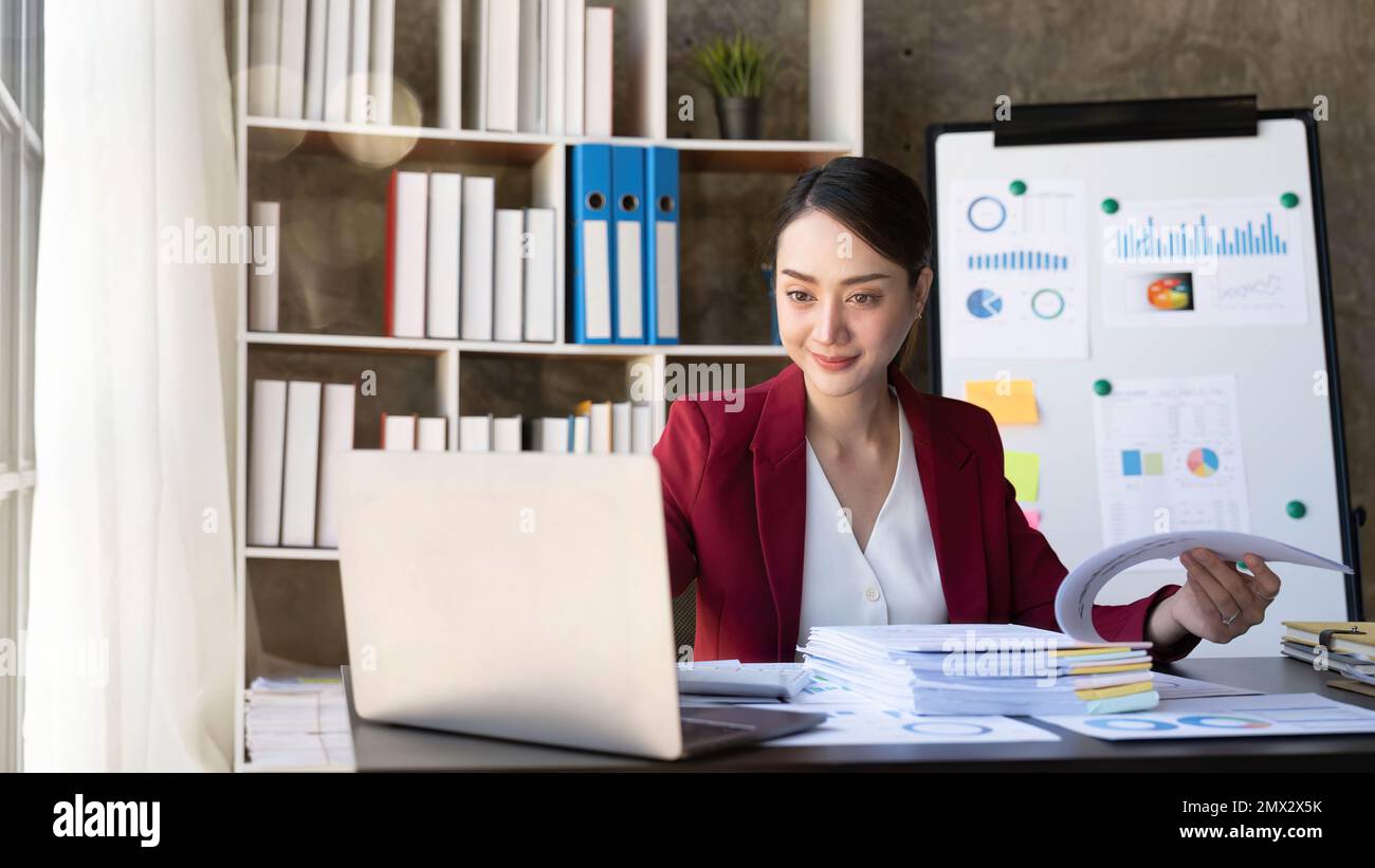 Happy young asian woman working and data graph backside Stock Photo - Alamy