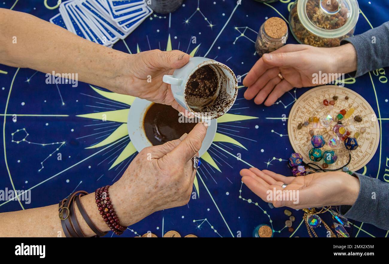 A fortune teller reads fortunes on coffee grounds. Selective focus. Woman Stock Photo Alamy