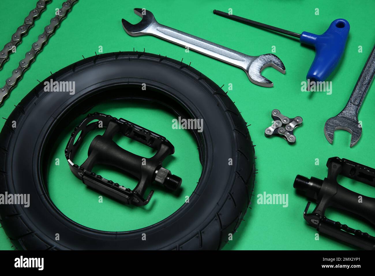 Set of different bicycle tools and parts on green background Stock
