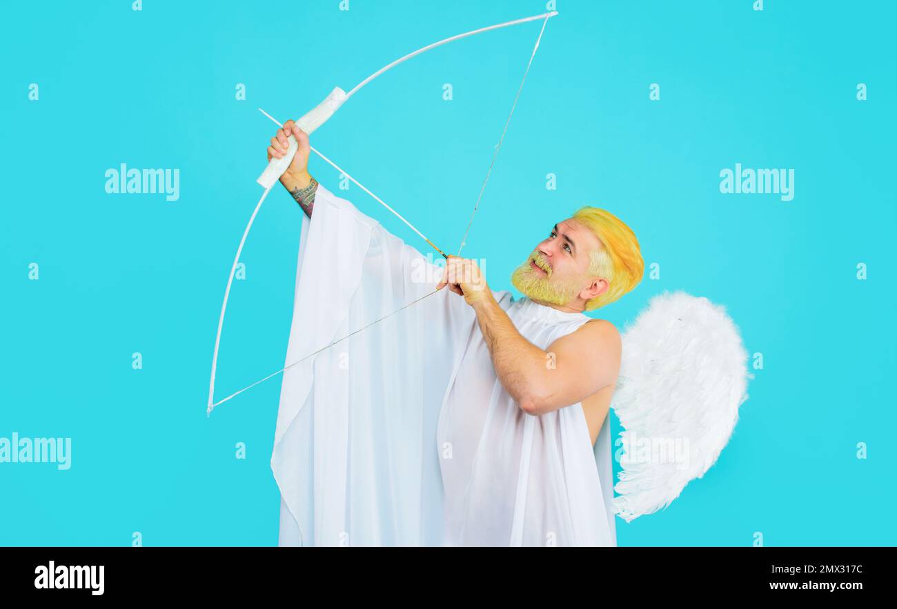 Valentines day cupid. Male angel aiming up with bow and arrow. God of love. February 14. Stock Photo