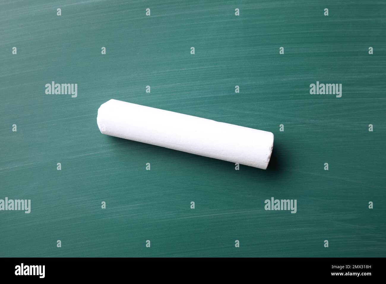 Piece of white chalk on greenboard, top view Stock Photo