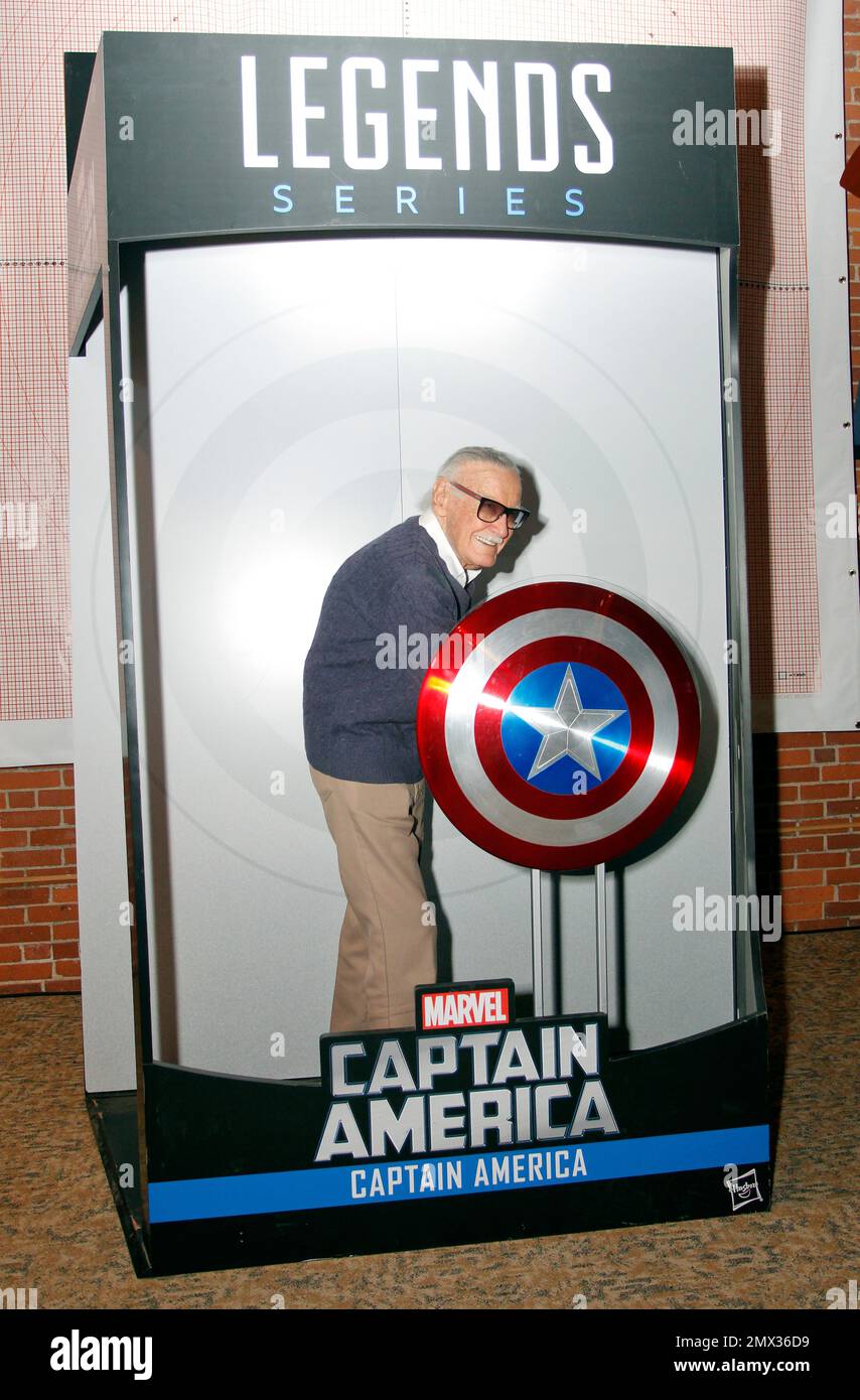 Marvel Comics legend Stan Lee, poses as Captain America in a Hasbro Legends  larger-than-life action figure pack during a visit to the Hasbro  Headquarters in Pawtucket, . , Thursday, Nov. 10, 2016. (