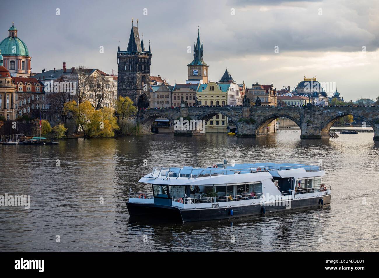 Panorama of beautiful ancient tower, building, church and part of Charles bridge, river Vltava with boat. Czech republic, Prague. Stock Photo