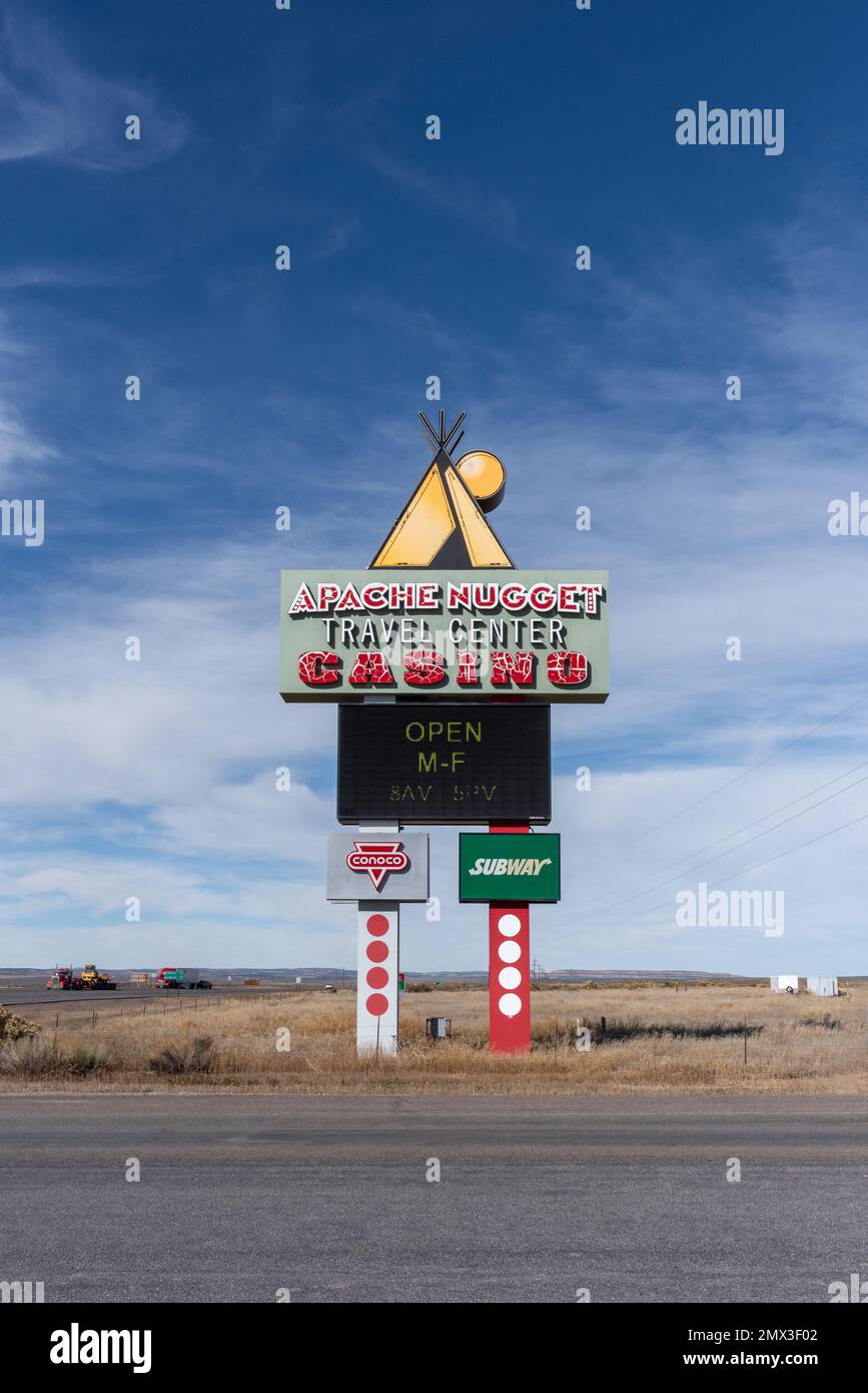 Pylon LED sign alongside road advertises the Apache Nugget Casino and Travel Center, Conoco gas station and Subway restaurant near Dulce,  New Mexico. Stock Photo