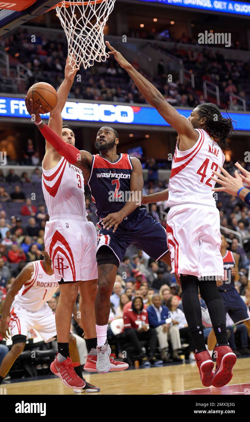 REMOVES REFERENCE TO PRESEASON GAME Washington Wizards guard John Wall (2)  goes to the basket between Houston Rockets forward Ryan Anderson (3) and  center Nene (42), of Brazil, during the second half