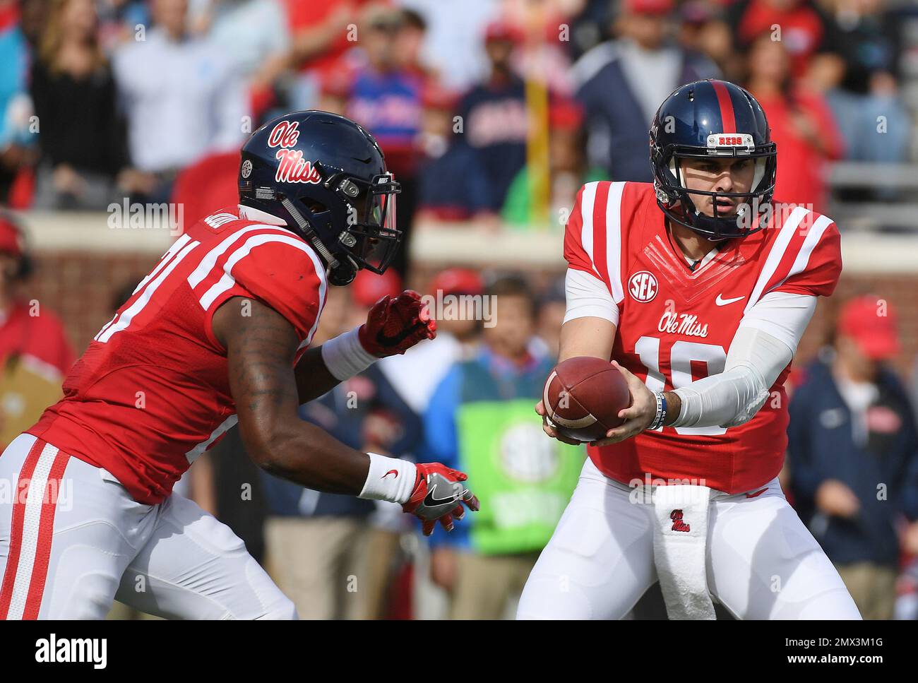 Mississippi quarterback Chad Kelly (10) hands the ball off to running