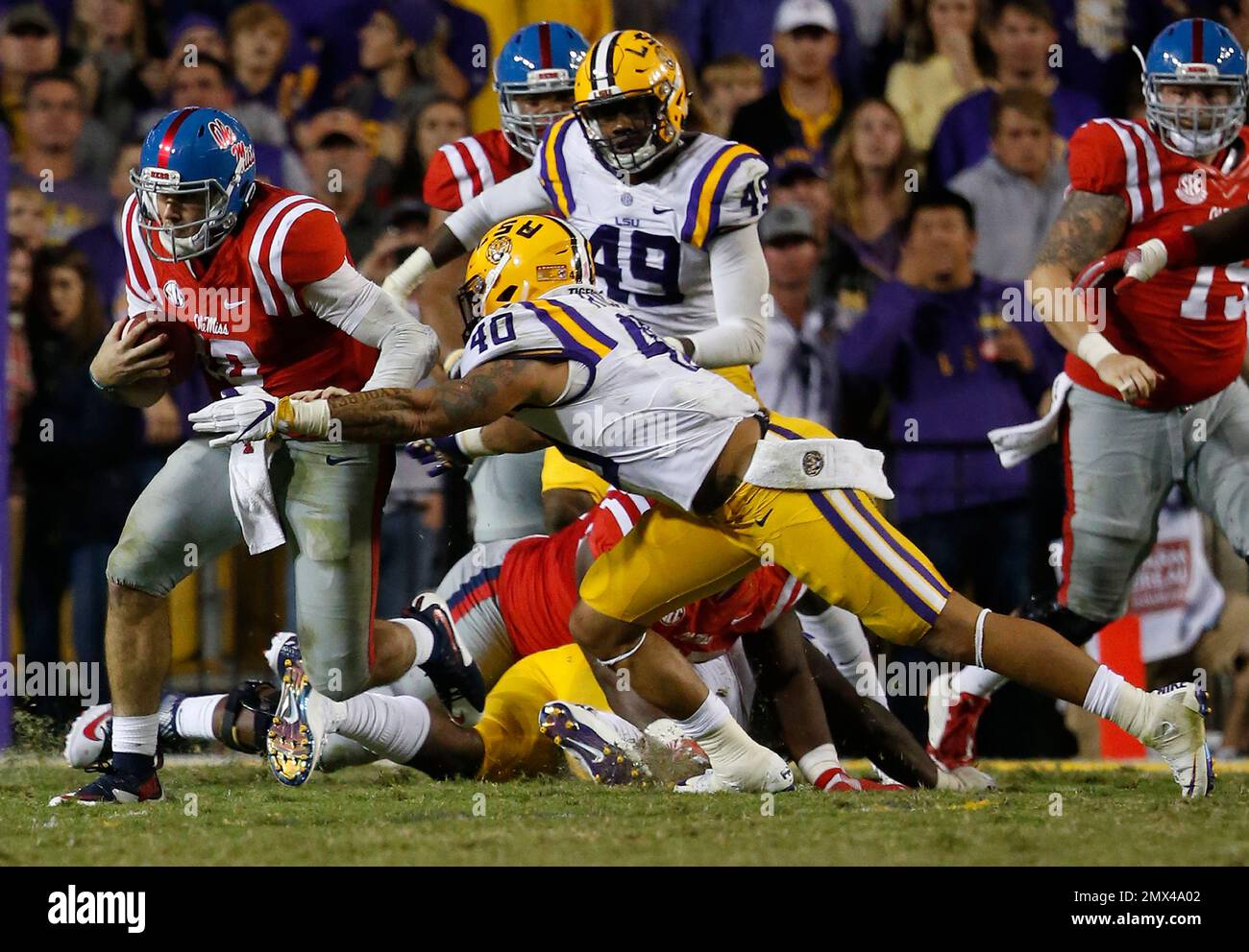 Mississippi quarterback Chad Kelly, left, runs from a tackle by LSU