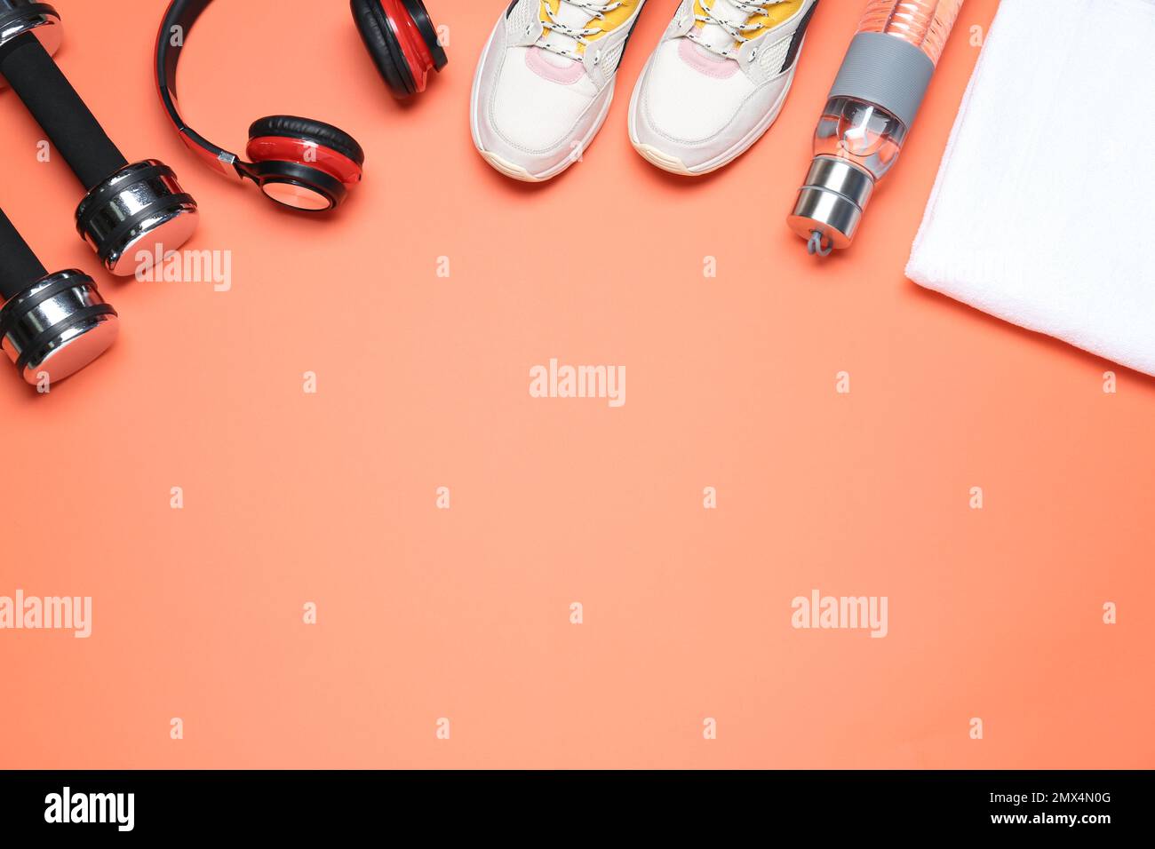 Flat lay composition with sport items on coral background, space for text Stock Photo