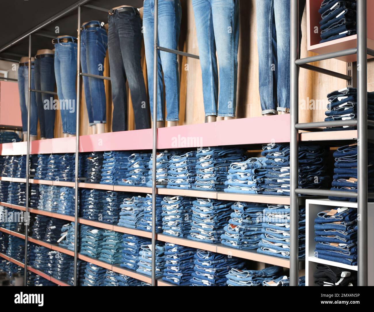 Collection of modern jeans on display in shop Stock Photo Alamy